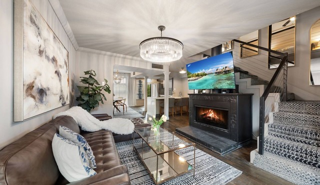 Expansive 2-bed loft with fireplace, full kitchen, smart TVs, sofa bed, and access to an award-winning courtyard & resort pool.