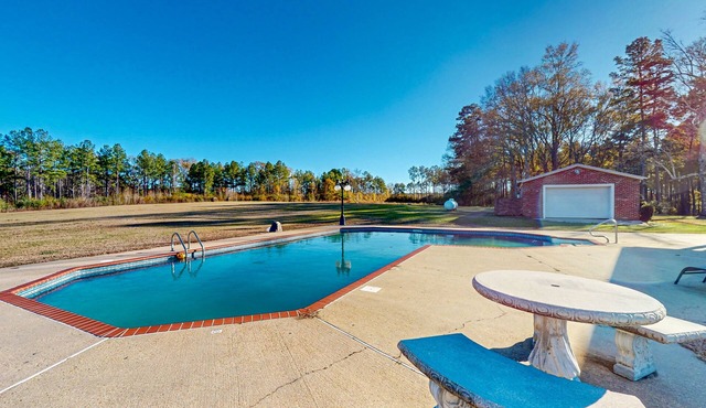 Expansive property with two homes, ponds, pool, game tables, & hiking trails