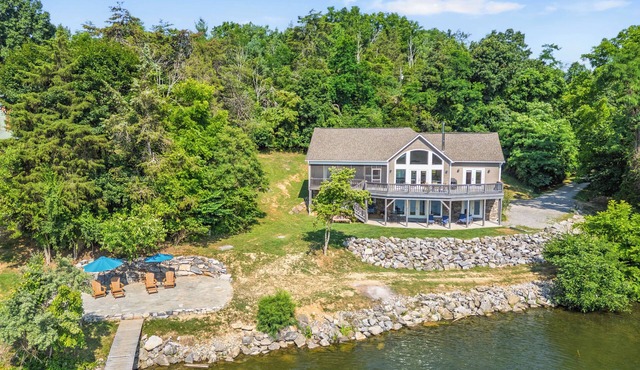Experience the perfect blend of rustic charm and modern luxury in this Claytor lakefront retreat