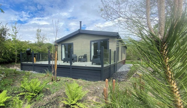 Experience the ultimate retreat in this stunning woodland lodge.