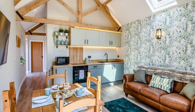 Exposed beams and calming green colours for this holiday home.