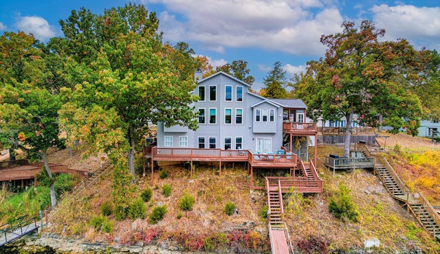 Exquisite lakefront home with game room, dock, balcony, central AC, & W/D