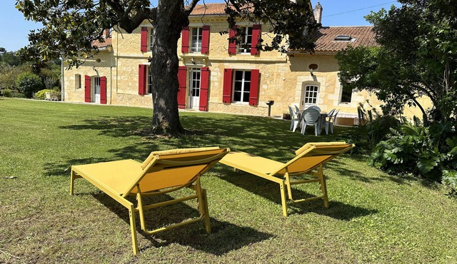 Family house on a Bordeaux winery, overlooking a garden with century old trees
