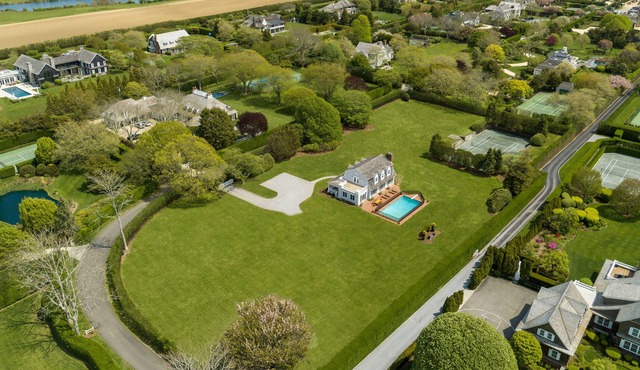 Family friendly home with private beach access with tennis court on 2.6 acres.