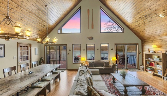 Family-friendly lakefront cabin/chalet with incredible views, private beach, lakeside firepit, boats, hot tub, multiple game rooms, and more