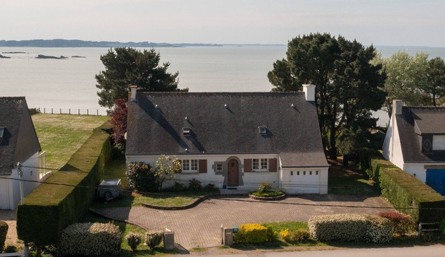 Family home with the ocean at the end of the garden.