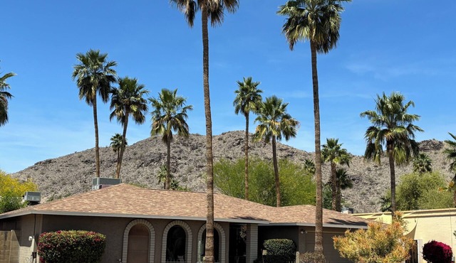 Family oasis with heated pool, desert landscaping and South Mountain views.
