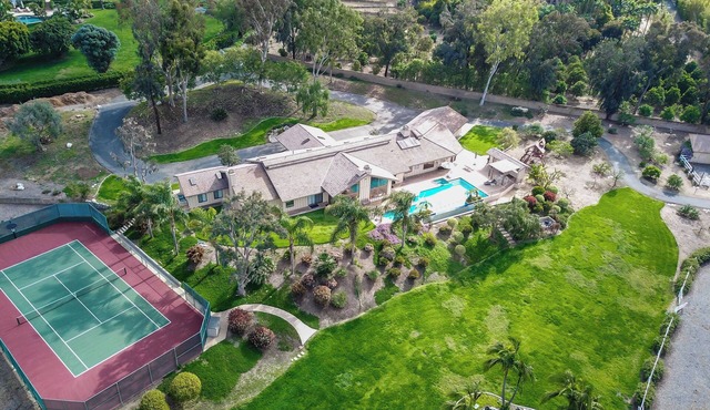 Family ranch w/ luxurious pool, spa & landscaping plus horse lodging!