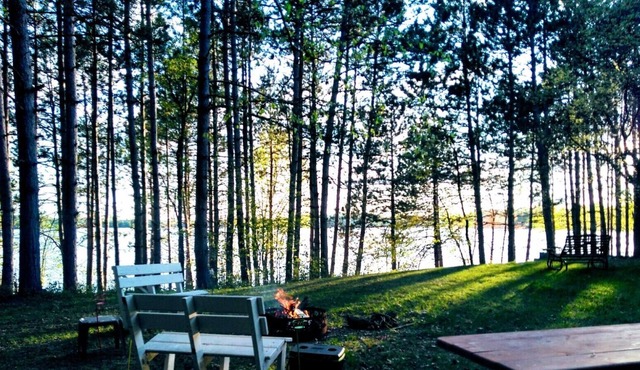Family vacation lake home with a beach, dock, and boats on Fireside Lake.