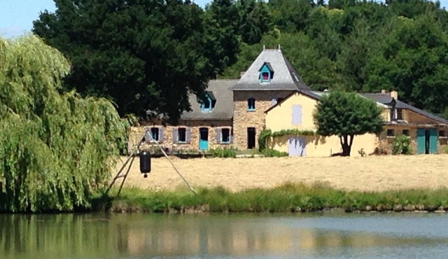 Farmhouse in the woods, on a lake shore