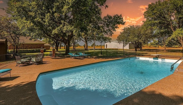 Farmhouse & Ranch style living for your vacay with pond, gazebo, trellis, pool.