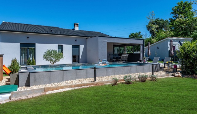 First floor villa with pool, surrounded by greenery