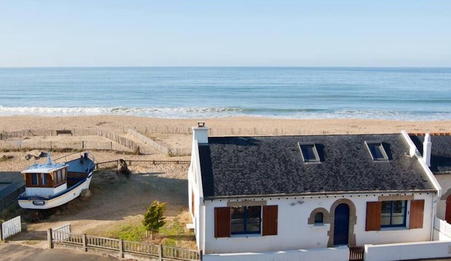 Fishermlan's house on the beach and his beached boat