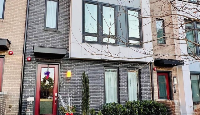 Four-level modern townhome with two grand pianos.