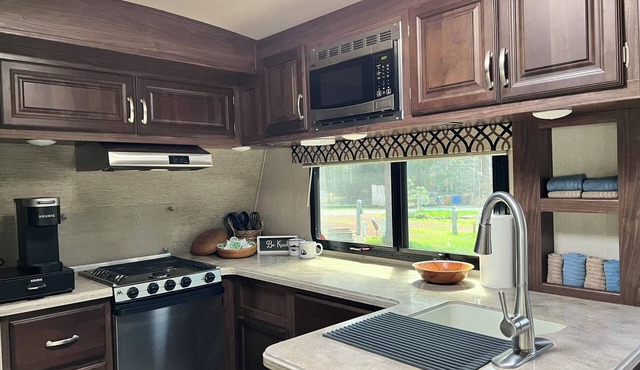 Fully Equipped Travel Trailer in beautiful campground setting.