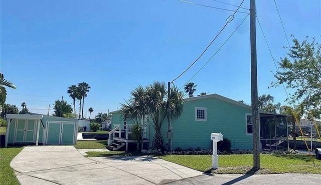 Fully remodeled, adorable coastal canal house on a spacious corner lot.