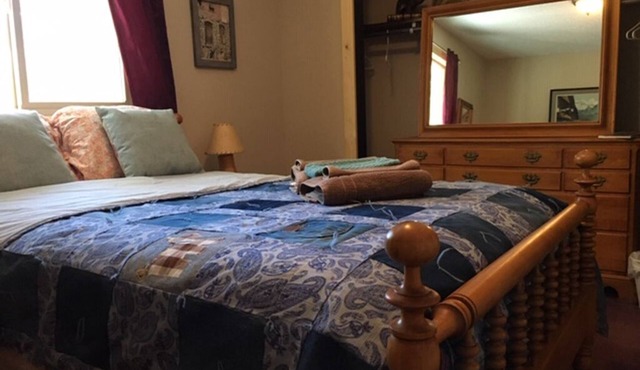 Furnished bedroom in our Home with full size bed, shared bath