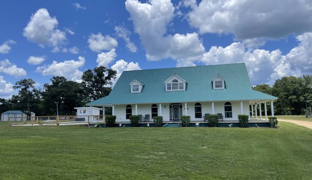 Gated Farmhouse on 93 acres pool & access to red creek from property.