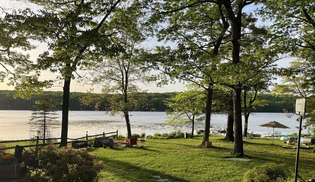 Glacial lake on top of mountain, boats, floating dock, fishing, swimming, beach.