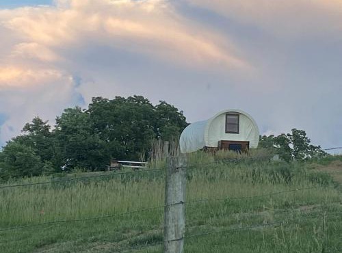 Glenwood Glamping Vacations at this Charming Covered Wagon Rental in Iowa