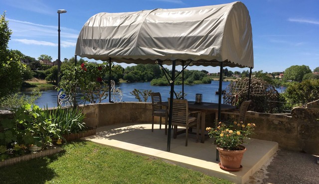 Glorious riverside town apartment with private garden overlooking La Dordogne .