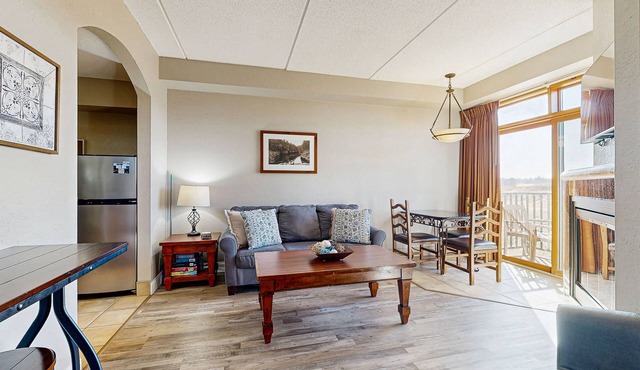Golf-front modern condo with fireplace, balcony, & golf course views