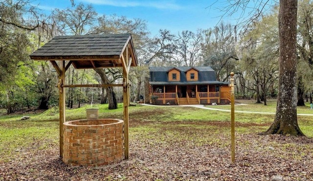 Gorgeous and peaceful 4-bedroom cabin with wooded landscape and gated entry.