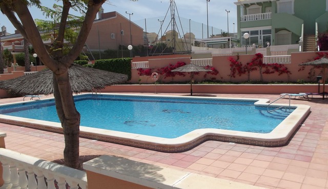 Ground floor corner apartment with WIFI, spacious sunbathing area and pool views