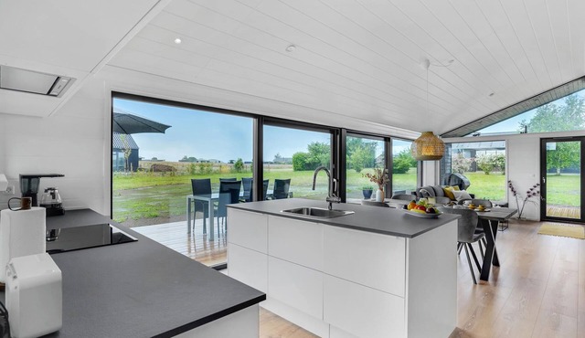 Here you can expect a modern vacation home with stylish interior and comfortable outdoor area.