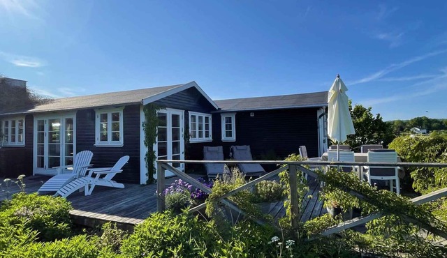 High-lying home with a view of the sea and forest