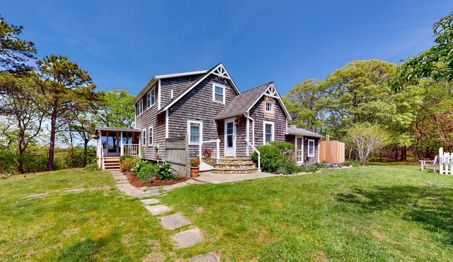 Historic, coastal home with water views, screened-in porch, large deck, & grill