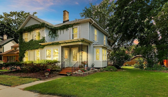 Historic house on tree lined red brick street of historic homes.
