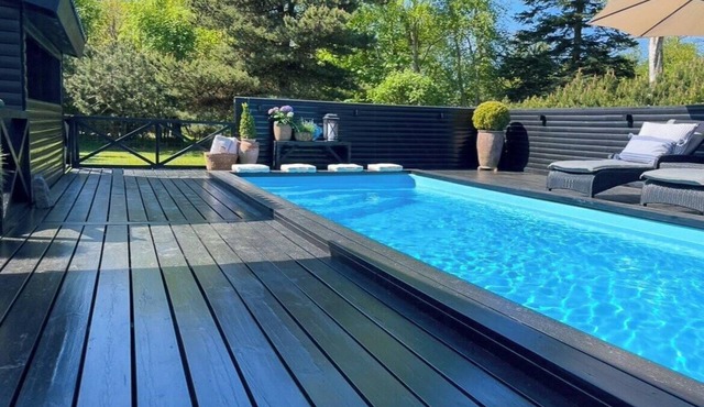 Holiday home with pool between beach and forest