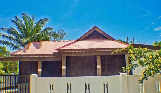 Holiday house in traditional wooden construction with massive cultivation