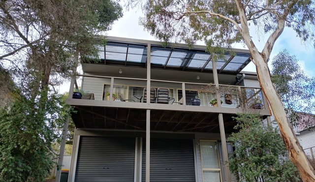 Holiday house nestled among native trees overlooking wetlands