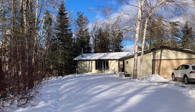 Home on Lake Huron with sandy beach and beautiful yards in Cheboygan, Michigan