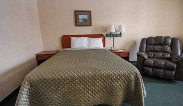 Hotel room with ONE QUEEN BED and attached, private bathroom.