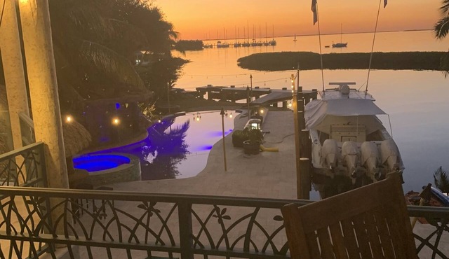 House and guest house with Boat dock, sunsets, jacuzzi, pool, slide, tiki, etc