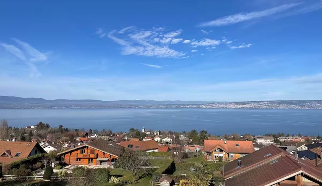 House between lake and mountains
