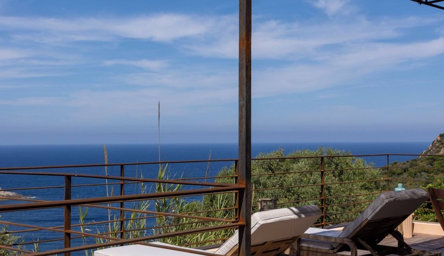 House between sea and scrubland near Arone beach in Piana, Corsica