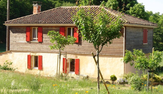 House in the countryside, with large expanses of woods and fields.