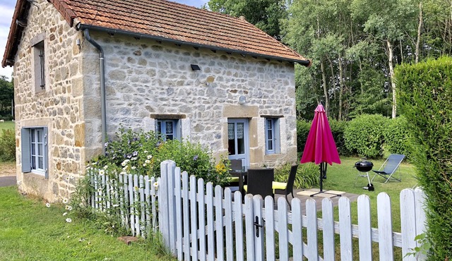 House made of regional stones, typical from Auvergne, greenery landscape