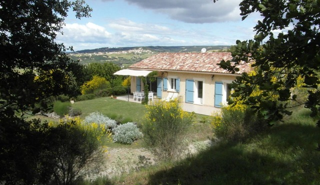 House on the hills of Provence overlooking vineyards .