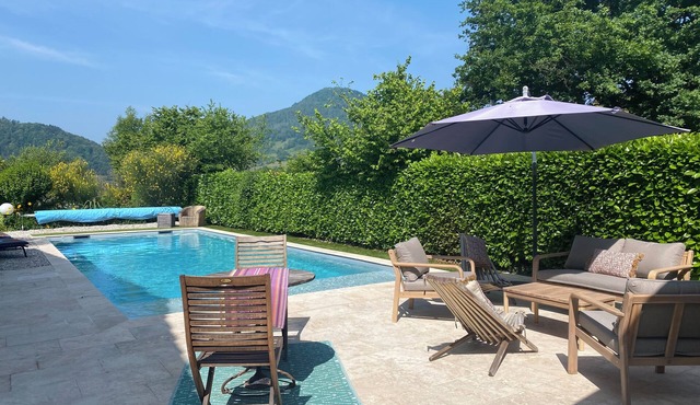 House with beautiful pool and wooded garden inviting you to relax.