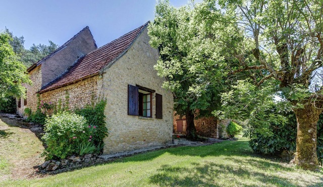 House with a large garden surrounded by nature