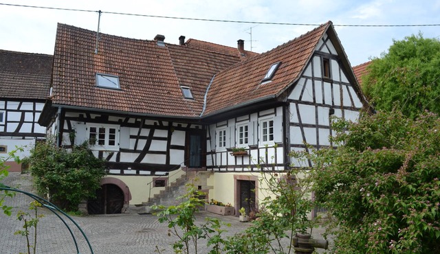 Idyllic half-timbered house with a large garden and playground and orchard