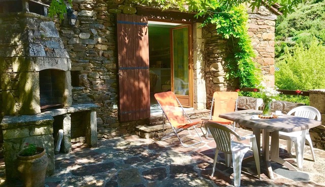 In a fantastic medieval village, house in stone with a nice view near the river
