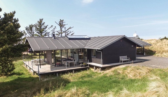 In the middle of the beautiful dune landscape with a view of the Lyngvig lighthouse is this beautifu
