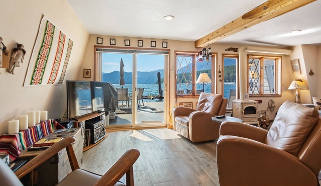 Incredible lakefront floating home with mountain views, balcony, & gas fireplace