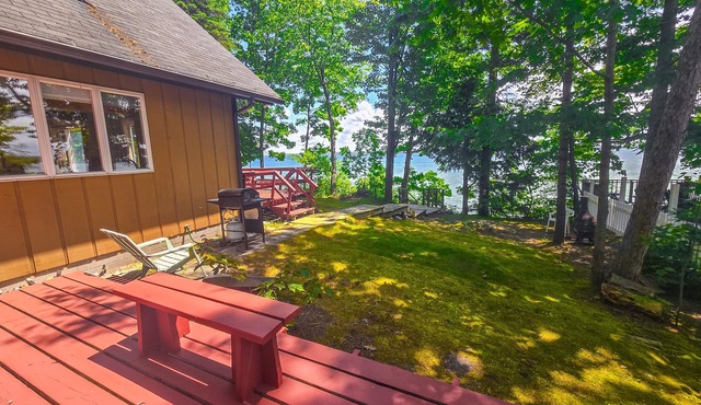 Incredible lakefront retreat with dock, fire pit, decks, yard, & amazing views